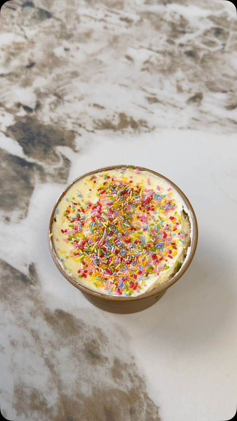 A sprinkle-topped cake ready on the counter